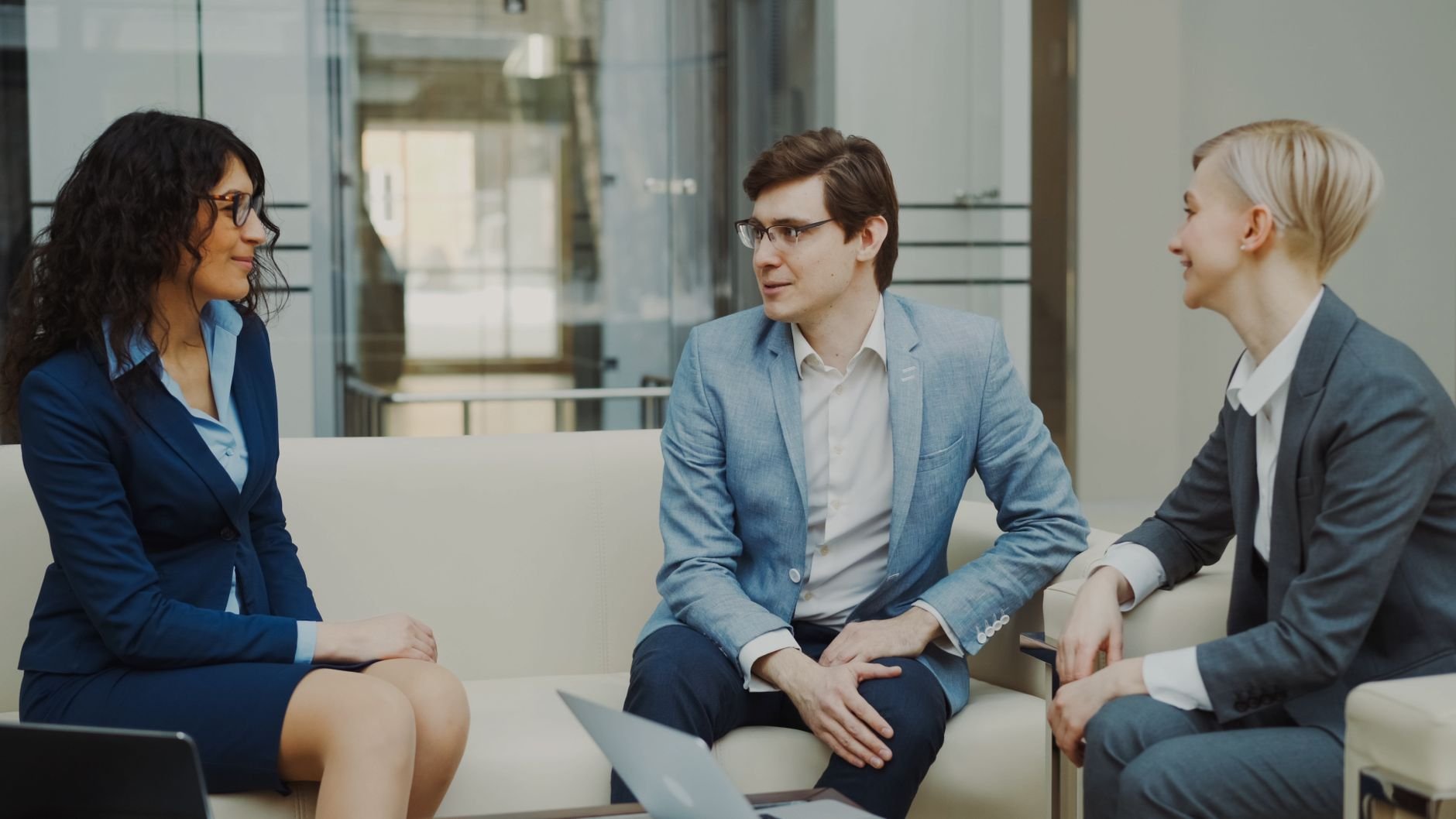 Three professionals in a business meeting, discussing safety compliance